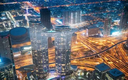Aerial bird's-eye view of Dubai cityscape skyline. Night traffic in residential district of Dubai. Street night yellow illumination in Dubai. Cityscape background of Dubai, UAE, United Arab Emirates. High quality photo